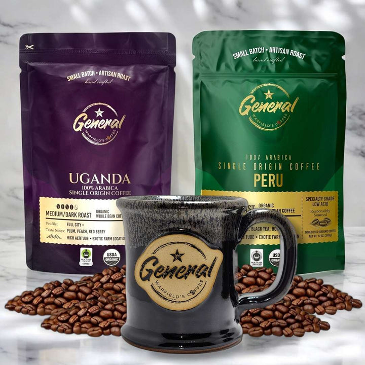 Organic Coffee Brew Bundle featured on marble surface highlighting the Organic certified Peruvian and Ugandan roasts with lead-free and cadmium-free handcrafted 14oz mug. 